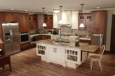 Inspiration for a large transitional l-shaped medium tone wood floor open concept kitchen remodel in Other with an undermount sink, shaker cabinets, medium tone wood cabinets, granite countertops, beige backsplash, ceramic backsplash, white appliances and an island