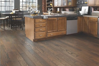 Inspiration for a large modern l-shaped dark wood floor open concept kitchen remodel in San Francisco with medium tone wood cabinets, stainless steel appliances, no island, a double-bowl sink, beaded inset cabinets and brick backsplash