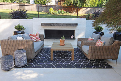 Inspiration for a mid-sized mid-century modern backyard concrete patio remodel in Atlanta with a fireplace and a pergola