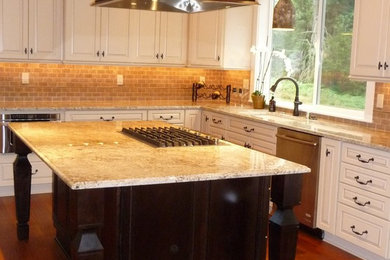 Mid-sized elegant u-shaped open concept kitchen photo in Seattle with raised-panel cabinets, dark wood cabinets, granite countertops and an island