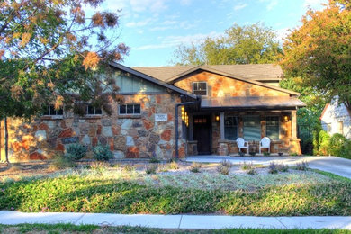 Photo of a mid-sized traditional one-storey brown house exterior in Dallas with stone veneer, a gable roof and a shingle roof.