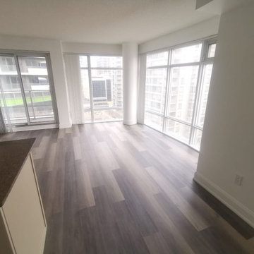 Corner-Window Living Space with Continuous Vinyl Plank Flooring | Toronto