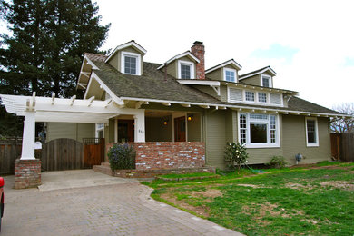 Large arts and crafts two-storey green house exterior in San Francisco with vinyl siding, a gable roof and a shingle roof.