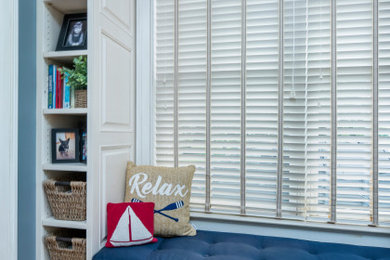 Mid-sized beach style built-in desk medium tone wood floor and brown floor study room photo in Columbus with blue walls