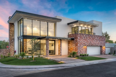 Inspiration for a large modern white two-story brick flat roof remodel in Phoenix