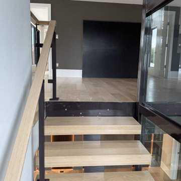 Project #136 | Modern Floating Staircase Encircling Glass Elevator