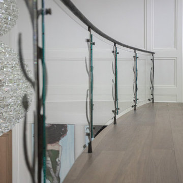 NATURE'S EMBRACE OF IRON AND GLASS RAILING