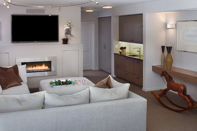 Photo of a modern living room in San Francisco with a ribbon fireplace, a wall-mounted tv and a metal fireplace surround.