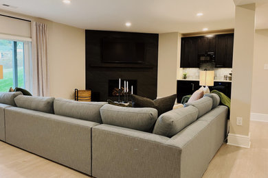 Example of a large minimalist walk-out vinyl floor and beige floor basement design in Other with a bar, beige walls, a corner fireplace and a tile fireplace