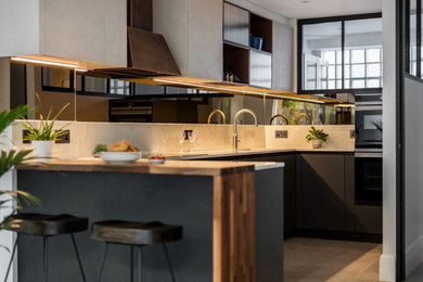 Inspiration for a small modern u-shaped open plan kitchen in London with a submerged sink, flat-panel cabinets, grey cabinets, stainless steel appliances, ceramic flooring, a breakfast bar and grey worktops.