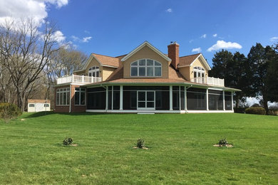 Large traditional beige two-story wood exterior home idea in DC Metro with a shingle roof