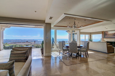 Great room - transitional travertine floor and beige floor great room idea in Orange County with beige walls