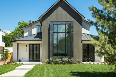 This is an example of a large country two-storey house exterior in Denver with a metal roof.