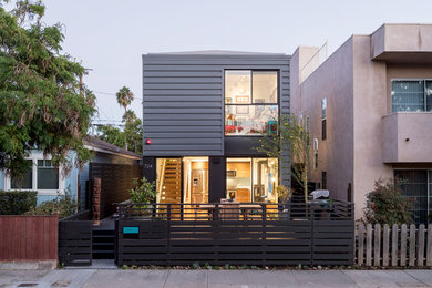 Example of a beach style gray flat roof design in Los Angeles