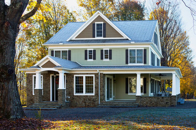 Mid-sized mountain style green three-story mixed siding gable roof photo in Other