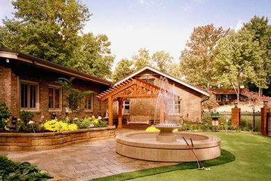 Photo of a mid-sized full sun backyard stone landscaping in Other for summer.