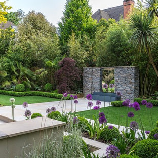 Inspiration pour un grand jardin à la française arrière ethnique avec un point d'eau et des pavés en pierre naturelle.