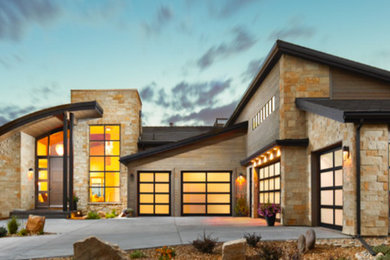 Example of a huge trendy attached four-car garage design in Denver