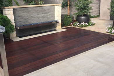 Inspiration for a contemporary backyard stone patio remodel in Orange County with a fire pit