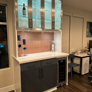 Modern Tiled Bar in white, with blue cabinets.