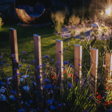 Contemporary Rural Garden with a View - night lighting on the cedar screen