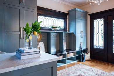 Inspiration for a mid-sized transitional brown floor and medium tone wood floor entryway remodel in Seattle with a dark wood front door and beige walls