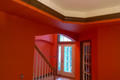 Example of a dining room design in New York with orange walls