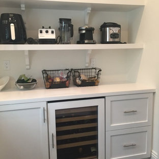 Large transitional kitchen pantry remodeling - Large transitional u-shaped dark wood floor kitchen pantry photo in Orange County with recessed-panel cabinets, white cabinets and solid surface countertops