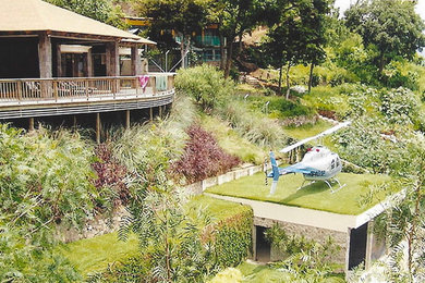 This is an example of a large mediterranean drought-tolerant hillside concrete paver retaining wall landscape in Chicago.