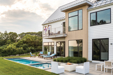 Photo of a contemporary backyard patio in Portland Maine with a fire feature, concrete pavers and no cover.