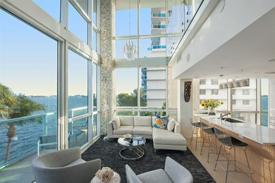 Mid-sized contemporary formal loft-style living room in Miami with white walls and porcelain floors.