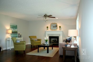 Family room - transitional dark wood floor family room idea in Louisville with gray walls and a standard fireplace