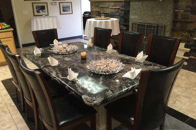 Mid-sized elegant porcelain tile enclosed dining room photo in Denver with beige walls, a standard fireplace and a stone fireplace