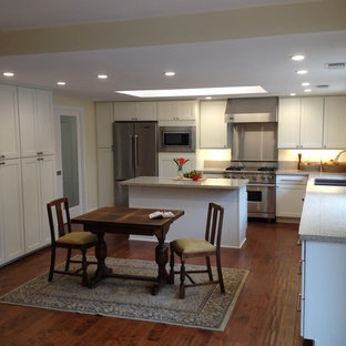 Mid-sized transitional kitchen pantry designs - Kitchen pantry - mid-sized transitional u-shaped medium tone wood floor kitchen pantry idea in Santa Barbara with an undermount sink, shaker cabinets, white cabinets, stainless steel appliances and an island