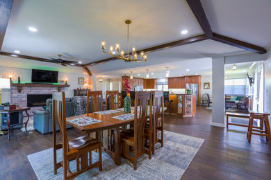 Dining room - transitional medium tone wood floor, brown floor and vaulted ceiling dining room idea in Kansas City with a standard fireplace and a brick fireplace