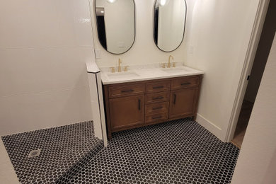 Inspiration for a large modern master black floor and double-sink bathroom remodel in Portland with recessed-panel cabinets, medium tone wood cabinets, white walls, an undermount sink, yellow countertops and a built-in vanity