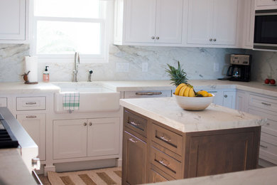 Inspiration for a large coastal u-shaped eat-in kitchen remodel in Jacksonville with shaker cabinets, white cabinets, marble countertops, multicolored backsplash, marble backsplash, stainless steel appliances and an island