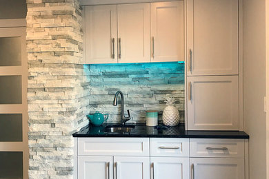 Example of a beach style kitchen design in Calgary