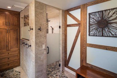 Bathroom - large rustic master beige tile and marble tile marble floor, beige floor, double-sink and wood wall bathroom idea in Philadelphia with shaker cabinets, medium tone wood cabinets, a one-piece toilet, blue walls, an undermount sink, soapstone countertops, a hinged shower door, gray countertops and a built-in vanity