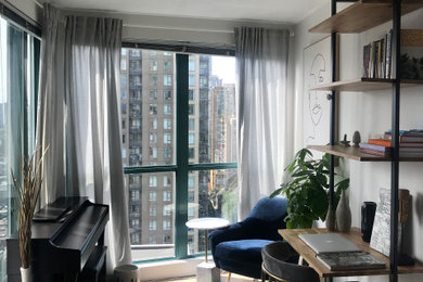 Mid-sized trendy laminate floor and beige floor home studio photo in Vancouver with white walls