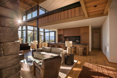 Huge trendy formal and open concept medium tone wood floor, brown floor, exposed beam and wall paneling living room photo in Seattle with white walls, a ribbon fireplace, a stone fireplace and a wall-mounted tv