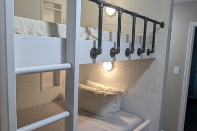 Small beach style gender-neutral vinyl floor and brown floor kids' bedroom photo in Birmingham with white walls