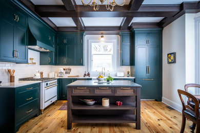 Inspiration for a transitional l-shaped light wood floor, beige floor and exposed beam kitchen remodel in Other with a farmhouse sink, shaker cabinets, blue cabinets, white backsplash, subway tile backsplash, white appliances, an island and white countertops