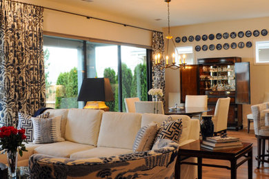 Inspiration for a mid-sized timeless open concept medium tone wood floor living room remodel in Boise with white walls