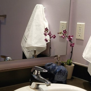 Immagine di una piccola stanza da bagno per bambini minimalista con ante lisce, ante in legno chiaro, vasca da incasso, WC monopezzo, pareti viola, pavimento con piastrelle in ceramica, lavabo da incasso e top in laminato