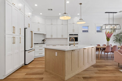 Open concept kitchen - mid-sized contemporary u-shaped light wood floor open concept kitchen idea in Phoenix with a farmhouse sink, shaker cabinets, white cabinets, red backsplash, an island and white countertops