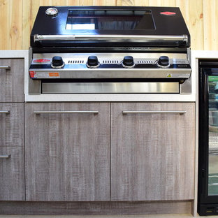 Small contemporary backyard patio in Melbourne with an outdoor kitchen and a gazebo/cabana.