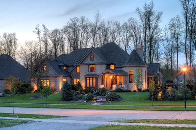 Large craftsman beige three-story brick gable roof idea in Cleveland