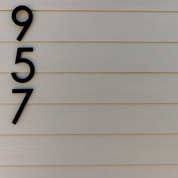 Warm Neutral Exterior Update | Taupe Siding with Modern Entry Door
