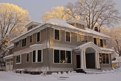 Example of a large transitional gray two-story wood exterior home design in Boston with a hip roof